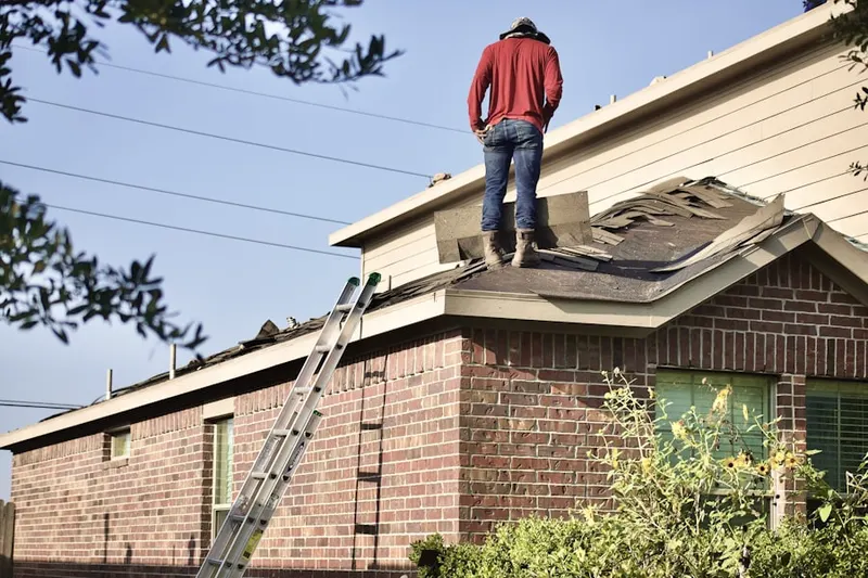 Professional roofer working on a residential roof in Stanton